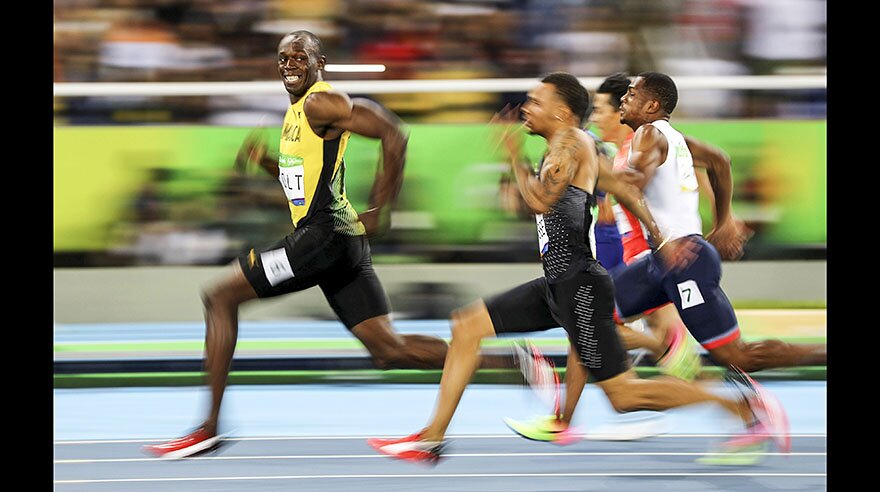 2016 Rio Olympics - Athletics - Semifinal - Men's 100m Semifinals - Olympic Stadium - Rio de Janeiro, Brazil - 14/08/2016. Usain Bolt (JAM) of Jamaica looks at Andre De Grasse (CAN) of Canada as they compete. Kai Pfaffenbach: "When Usain Bolt prepared for his 100m semi-final I decided to play with slow shutter speed for that race. I set my camera (shutter speed) to a 50th of a second and was waiting for the moment when he passed my position. In this very right moment he looked to his left with the proud smile and my first thought was: 'hopefully I got this sharp.' Well, I've been a lucky bunny in this case but I still would not have imagined at this moment that this picture would go viral and get worldwide recognition." REUTERS/Kai Pfaffenbach FOR EDITORIAL USE ONLY. NOT FOR SALE FOR MARKETING OR ADVERTISING CAMPAIGNS. SEARCH "OLY BEST" FOR THIS STORY. SEARCH "THE WIDER IMAGE" FOR ALL STORIES. TPX IMAGES OF THE DAY